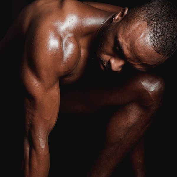 Man in a powerful and controlled athletic pose, symbolizing strength.
